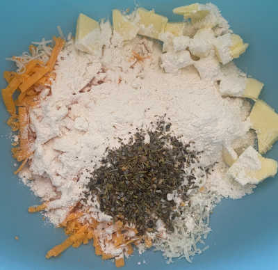 Plastic Bowl with ingredients for cheese and herb biscuits