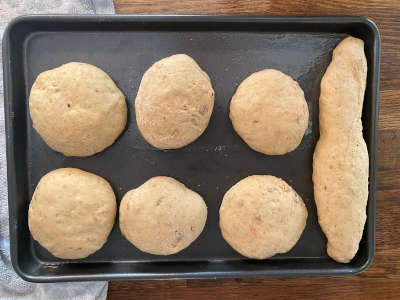 Brown buns proving on baking tray