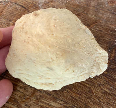 Stretching the dough by pinching the sides